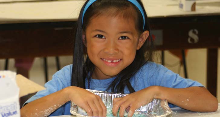 girl with hands in pan