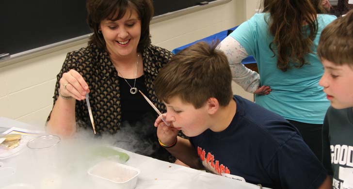 student blowing smoke