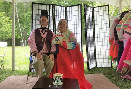 Assistant Provost Andrew Gillespie poses in Hanbok photo booth with wife Dee
