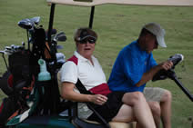 players on golf cart at golf tournament