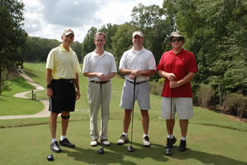 4 participants in the golf tournament pose before heading off