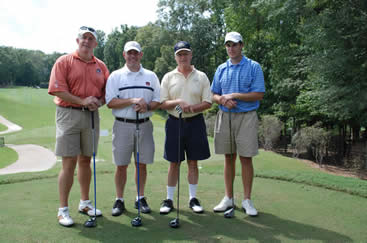 4 participants of the golf tournament pose before heading off