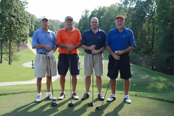 Four participants in the golf tournament pose before heading off