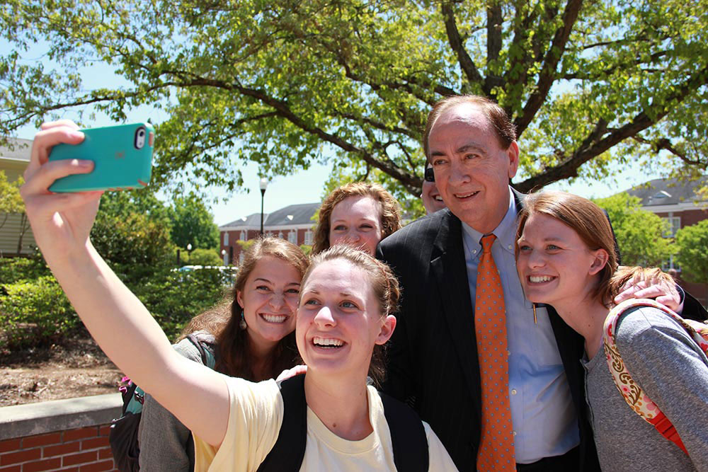 Jay Gogue poses with several students.
