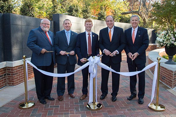 Auburn University President Jay Gogue and four others cut the ribbon on the Auburn Memorial.