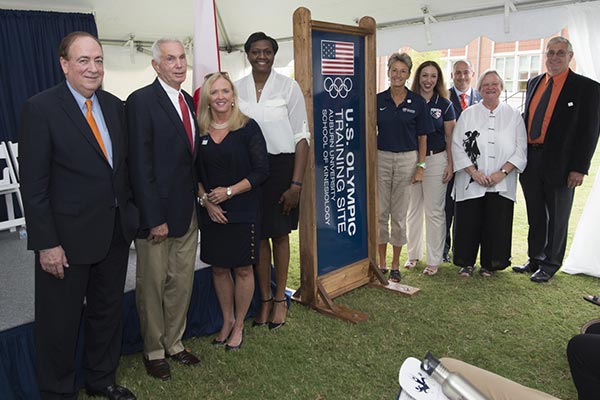 Jay Gogue and others stand at the front of a ceremony dedicating Auburn as an official training site for the Olympics.