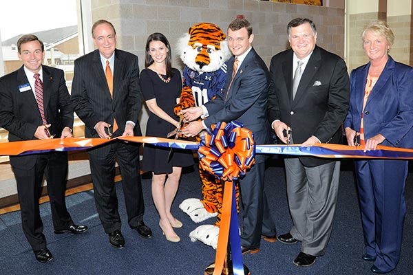 Auburn University President Jay Gogue is joined by Aubie and others to cut he ribbon at the Recreation and Wellness Center opening.