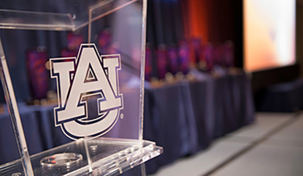 AU logo on clear podium during awards ceremony