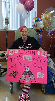 Stephanie Carroll holding poster celebrating Last day of Chemo