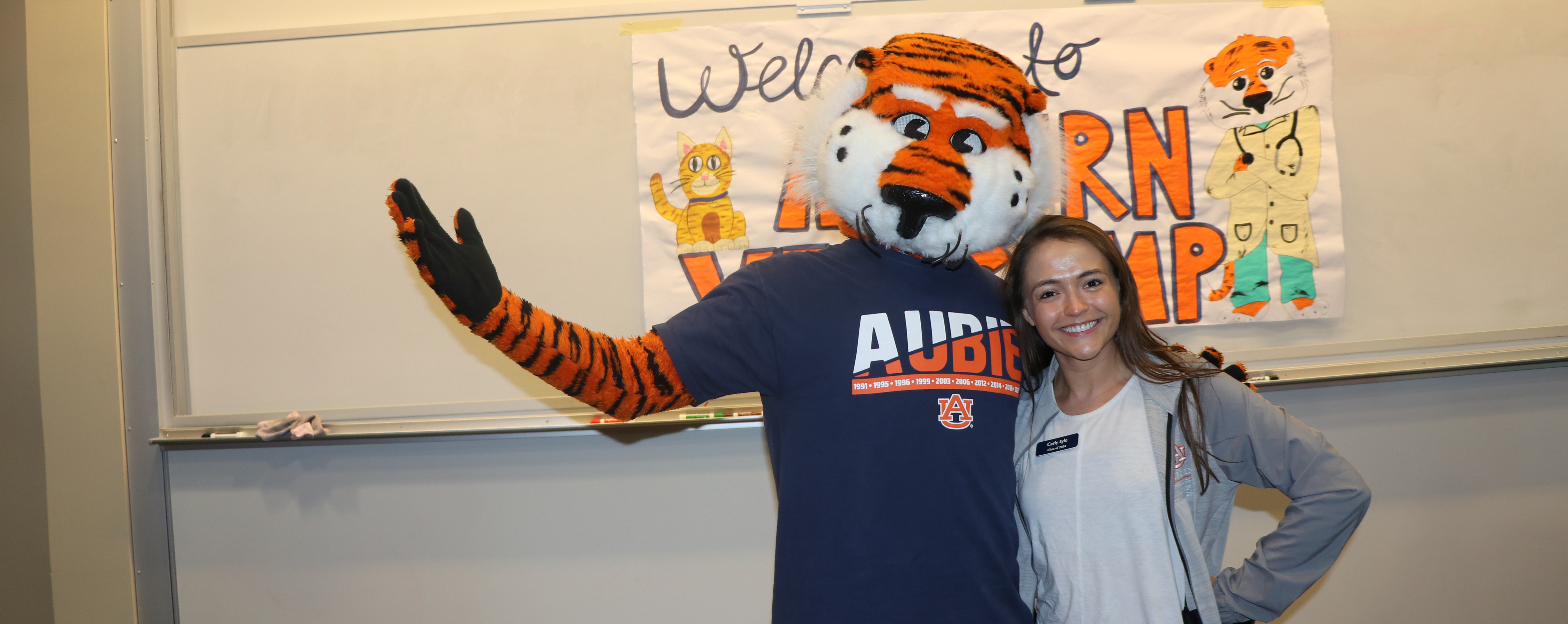 Vet Counselor Carly poses with Aubie the Tiger.