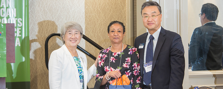 Group photo of Dr. Suh, Dr. Yu, and Yolanda Fears after she was presented with a gift at the conference.