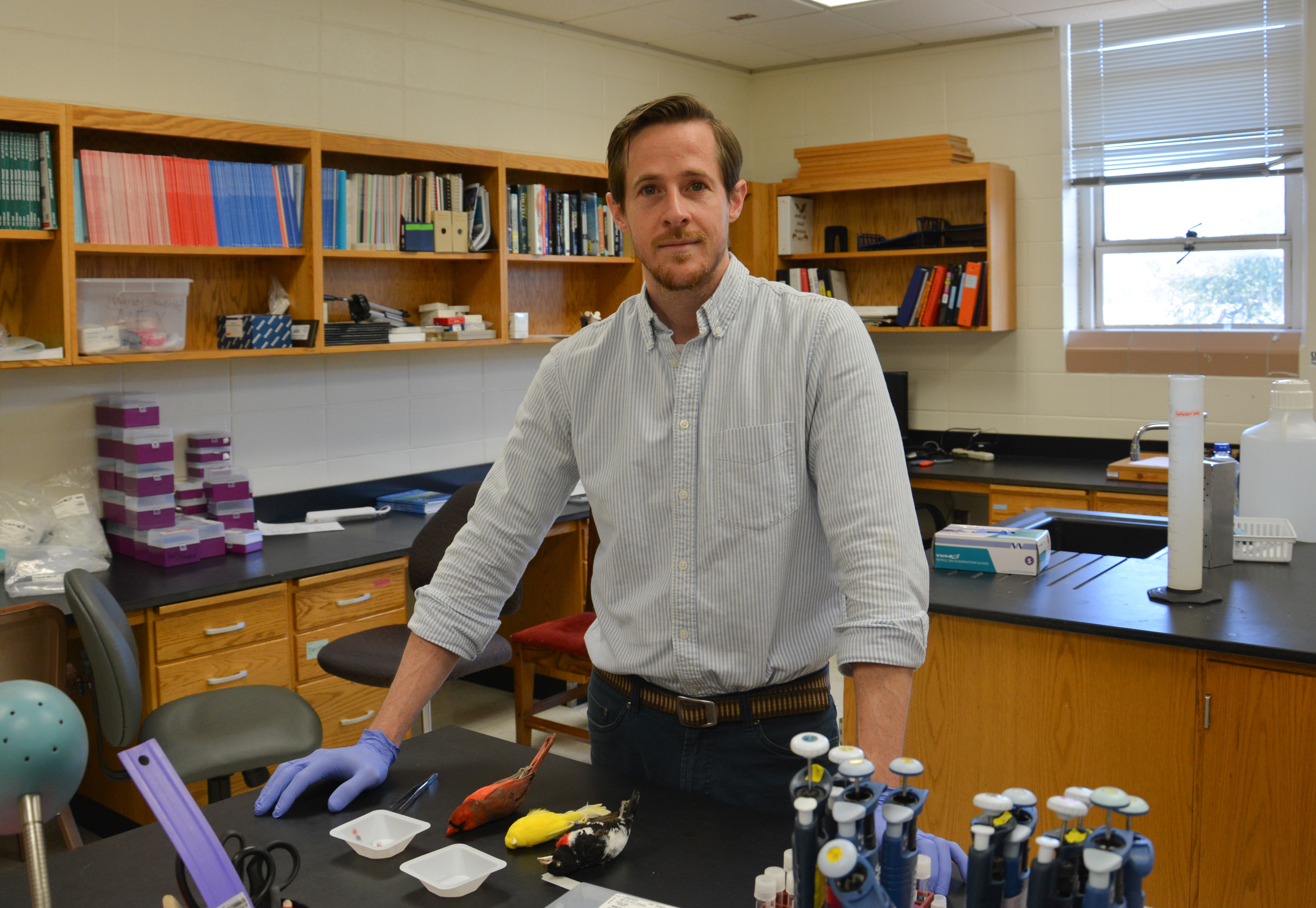Ryan Weaver standing at a table in the lab