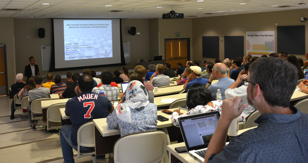 Dr. Merner speaks to a full room at the Chemistry Colloquium.