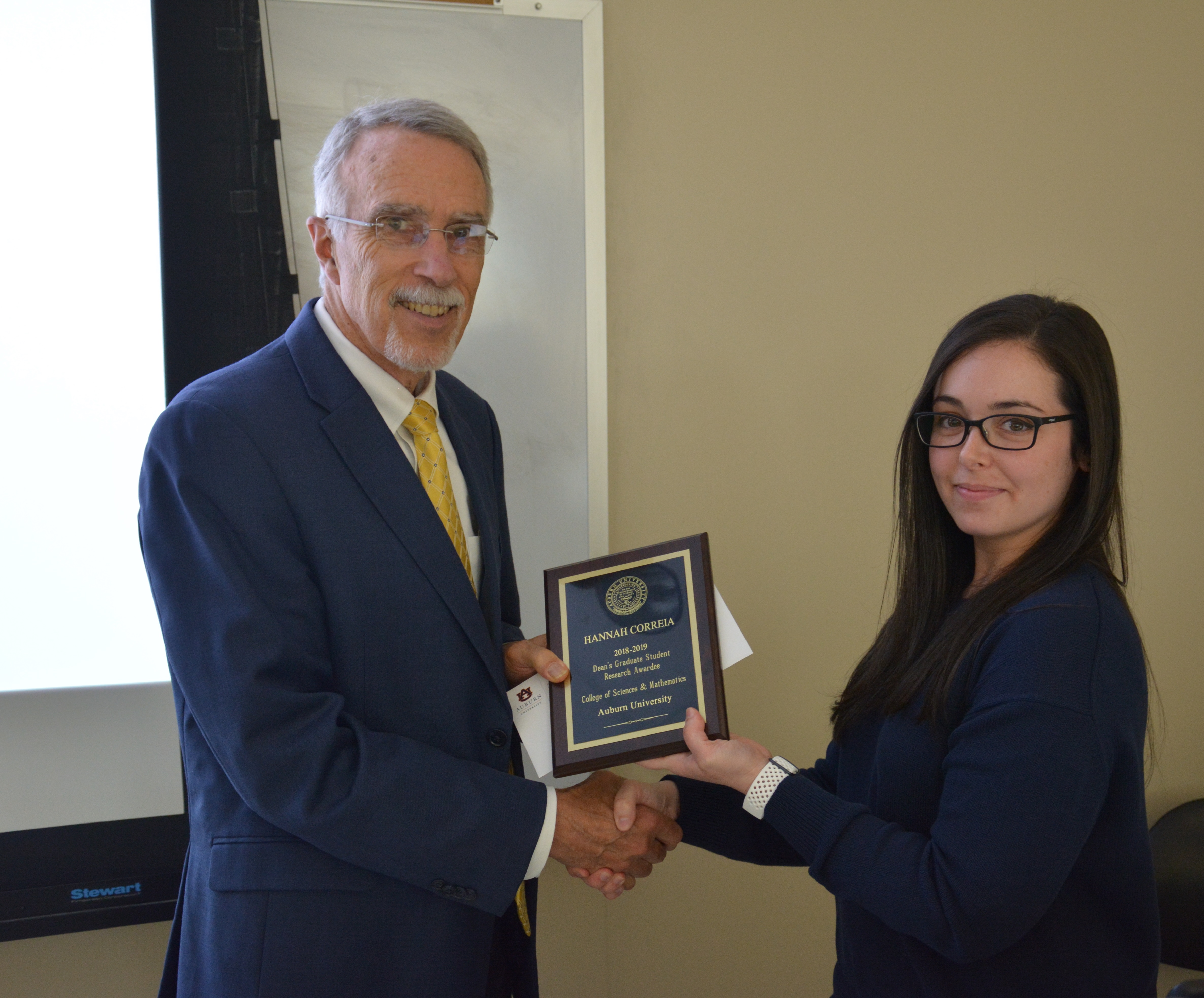 Dean Giordano presenting Hannah Correia, a doctoral student, with a Graduate Student Award.