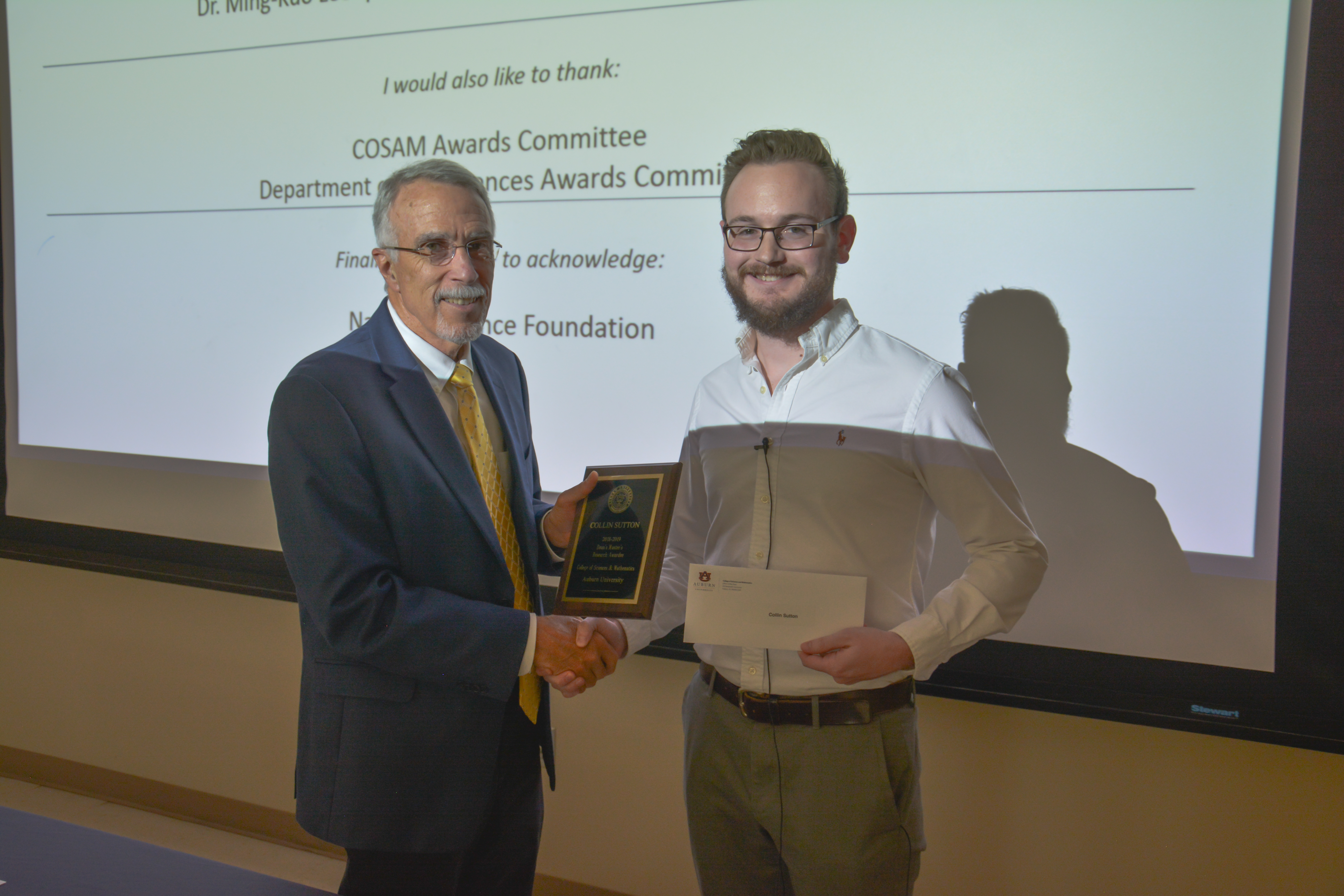 Dean Giordano presenting Collin Sutton with the Master's Student Award.