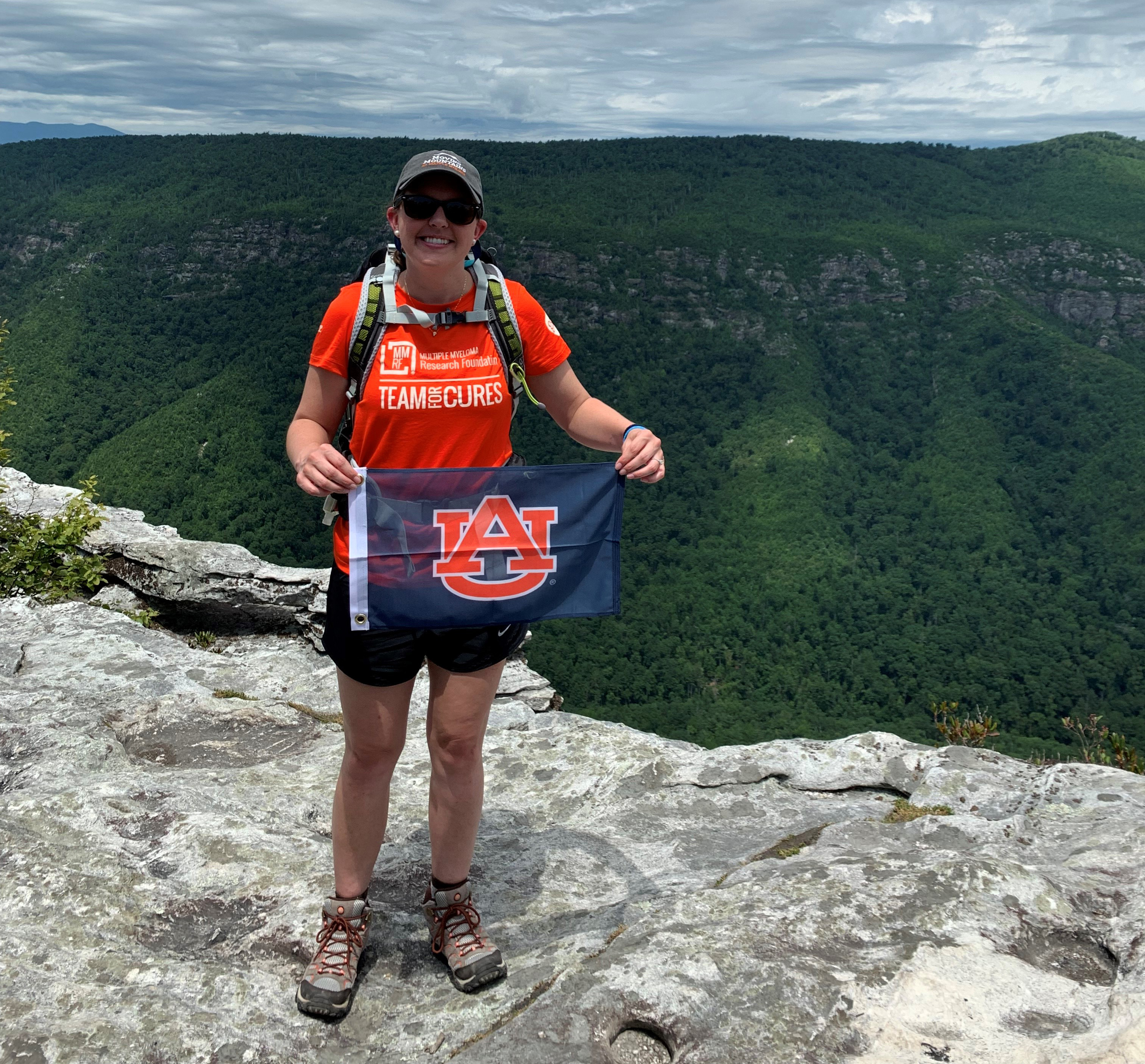 Meredith Jones holding an Auburn University flag in North Carolina.