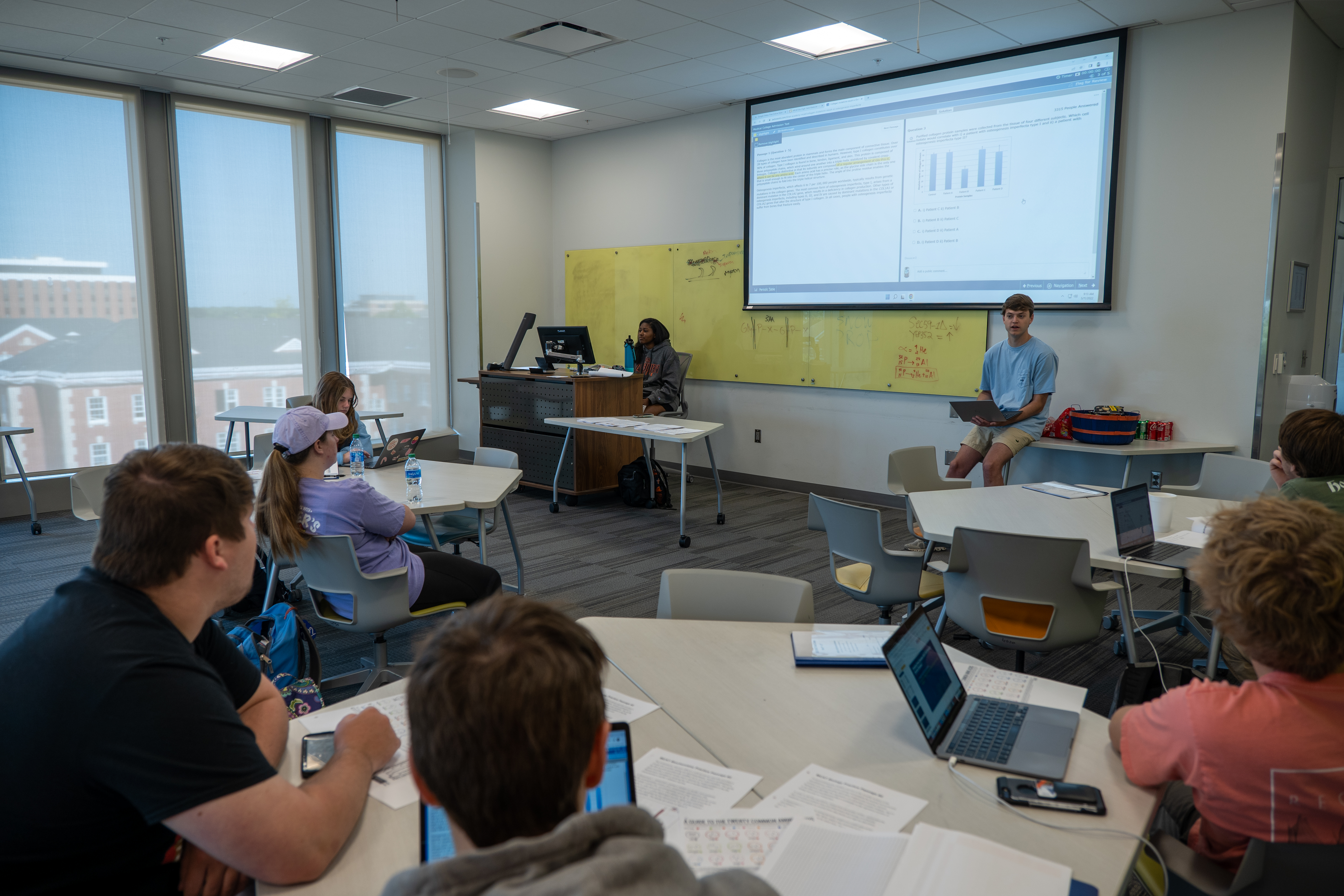 Instructors present information to students in a classroom setting.