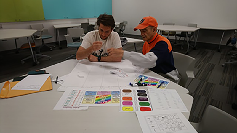 Two students working on a project at a table in Arabic Class