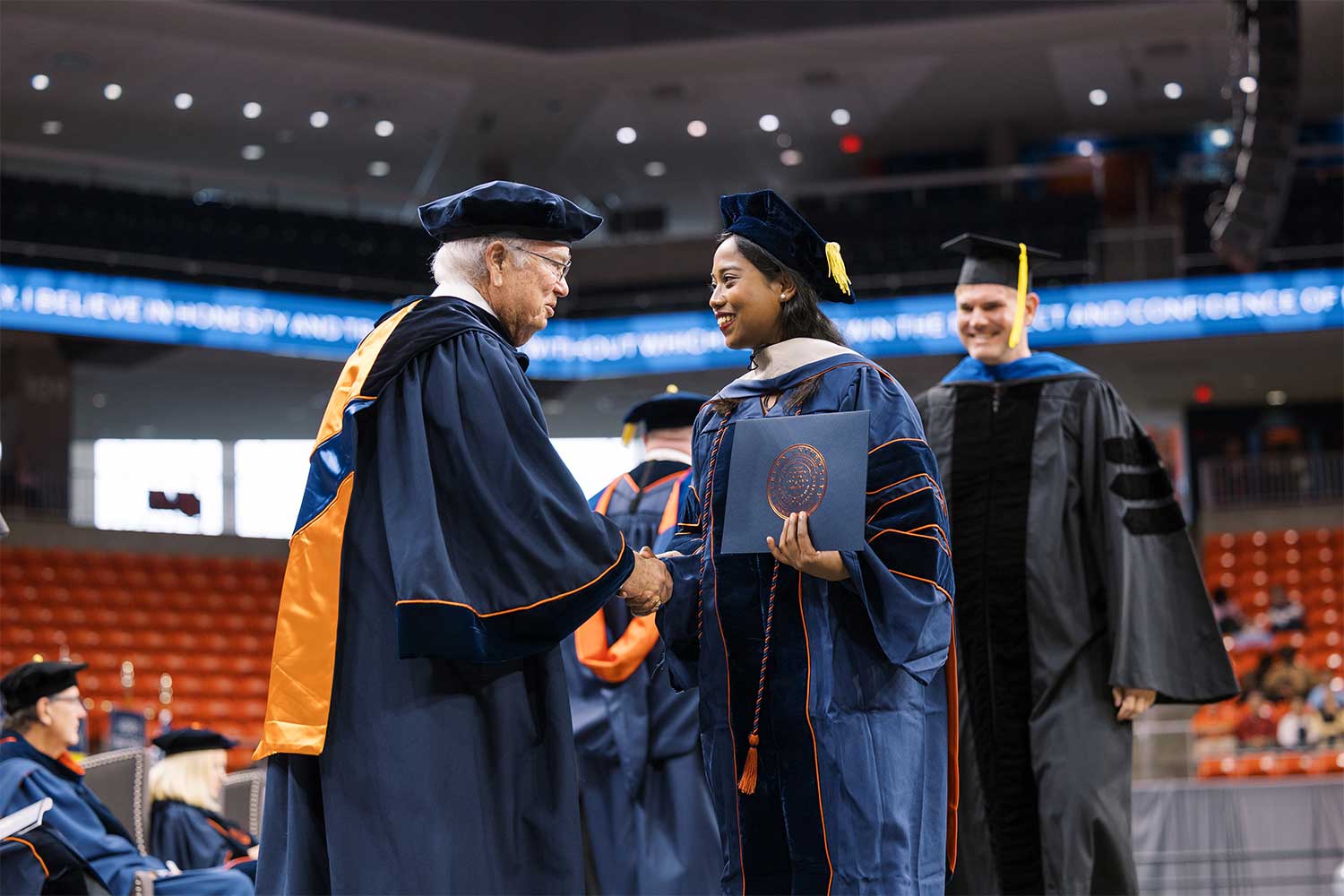 Fall 2025 Commencement student shaking hand