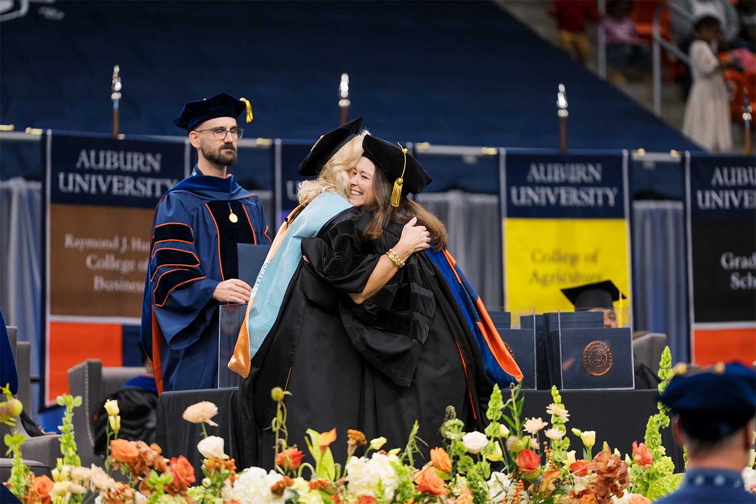 Fall 2025 Commencement student hugging