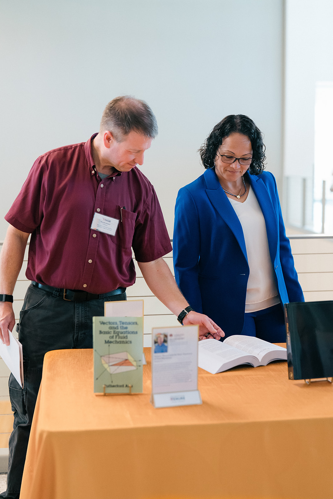 Promotion and Tenure 2024-2025 attendees at table reading