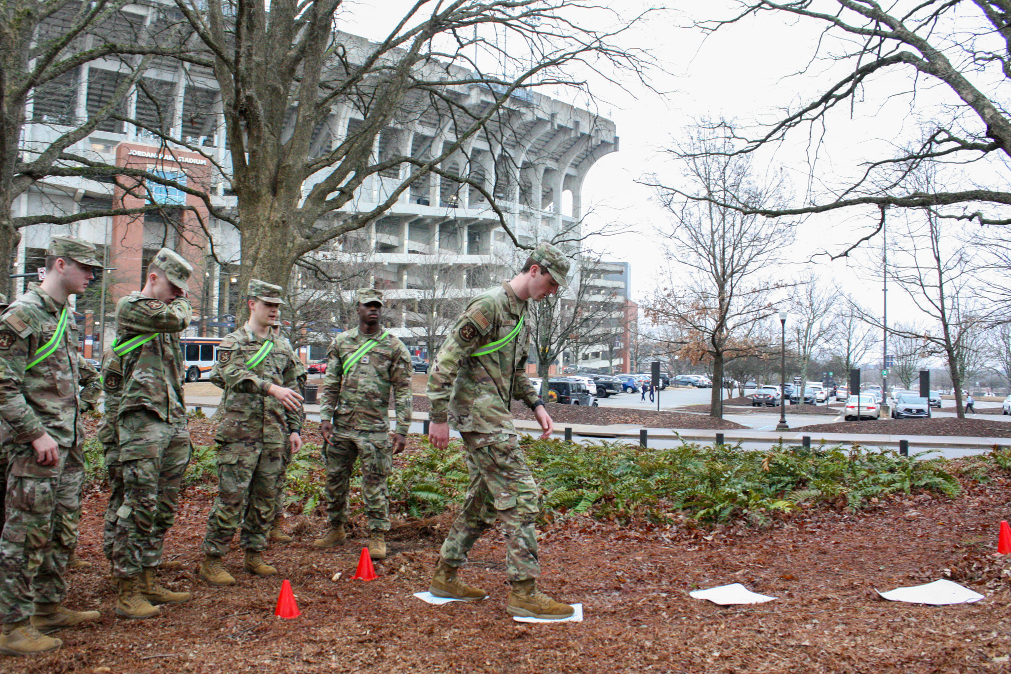 Cadet hanging upside down on a repel cord.