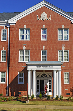 Student exiting Keller Residence Hall