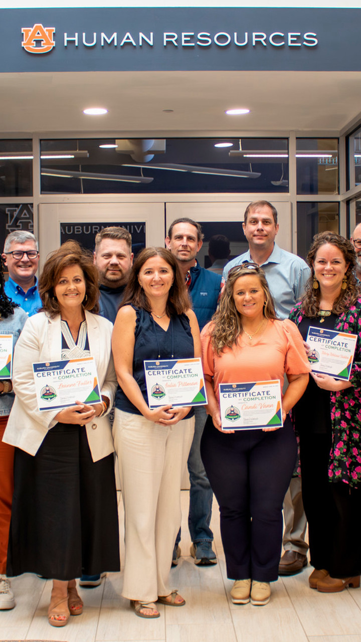 Group of people holding certificates