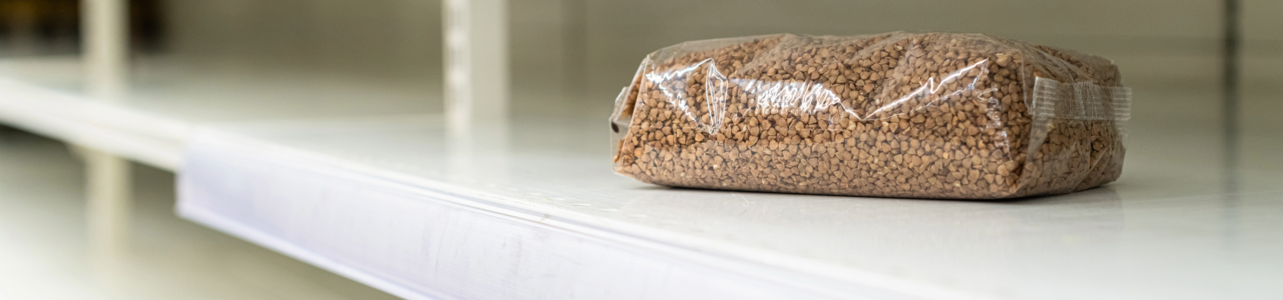 nearly empty food shelf with bag of beans