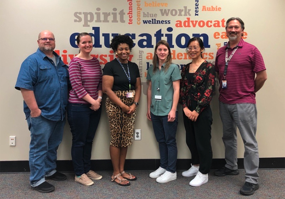 Auburn employees standing