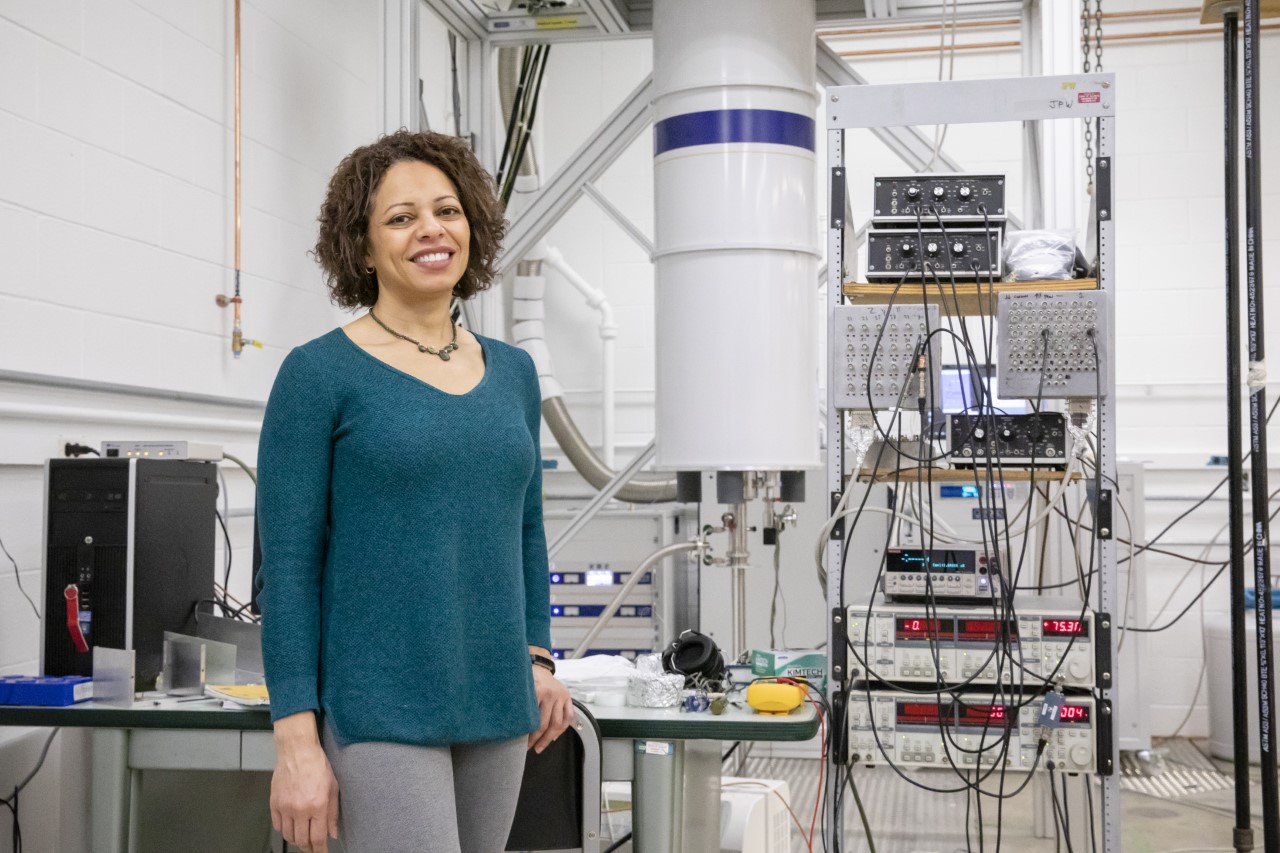 Professor Nadya Mason standing next to machinery in her lab