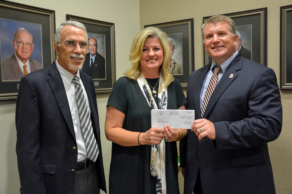 Joe Lovvorn presenting check to Mary Lou Ewald and Dean Nicholas Giordano