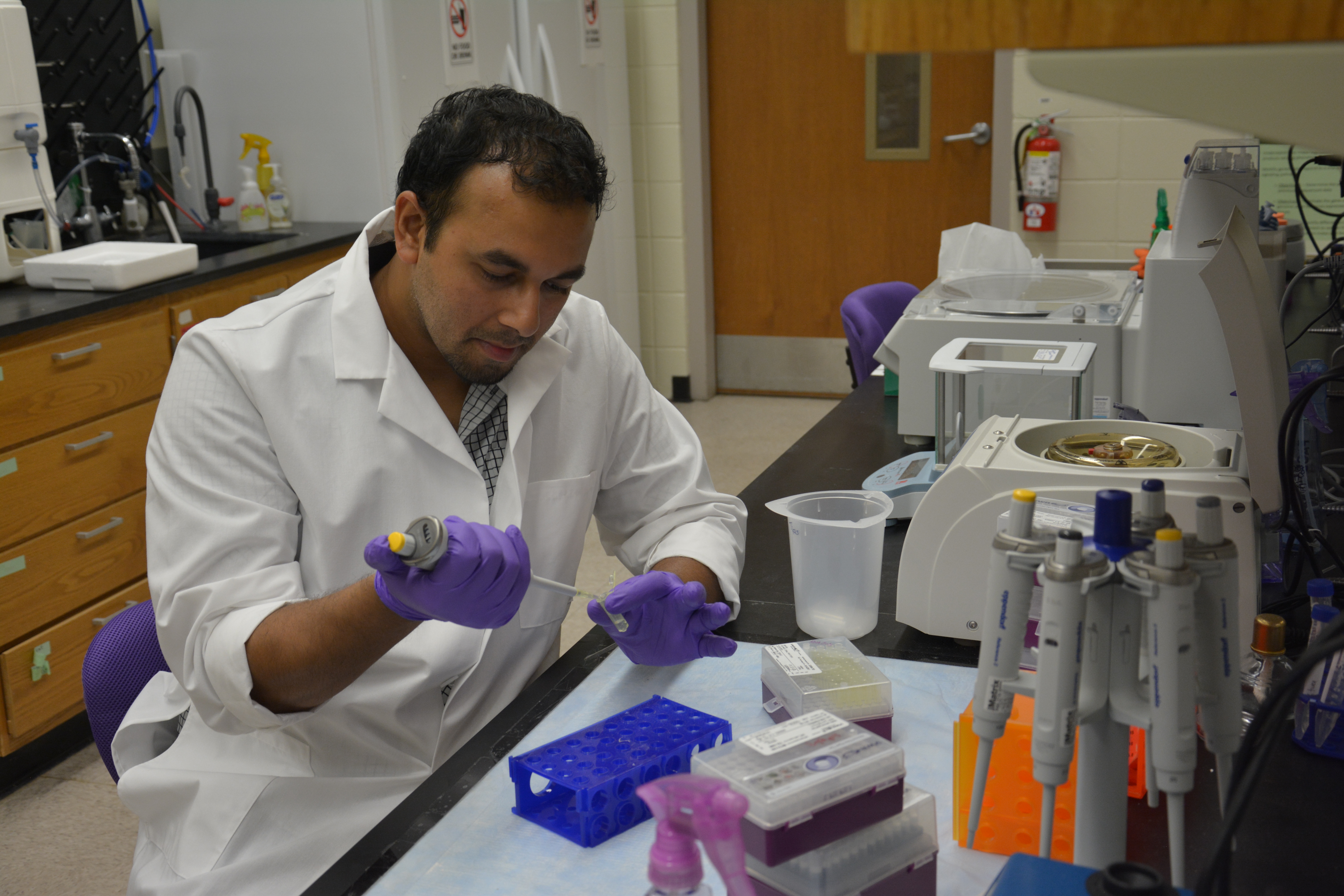 Mursalin Khan, a PhD student, conducts an experiment in the Graze Lab. 