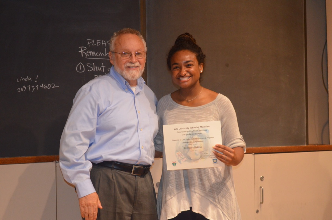 Kennedye McGhee proudly accepting her certificate from the creator of the internship program, Dr. Gil Mor, at Yale University.  