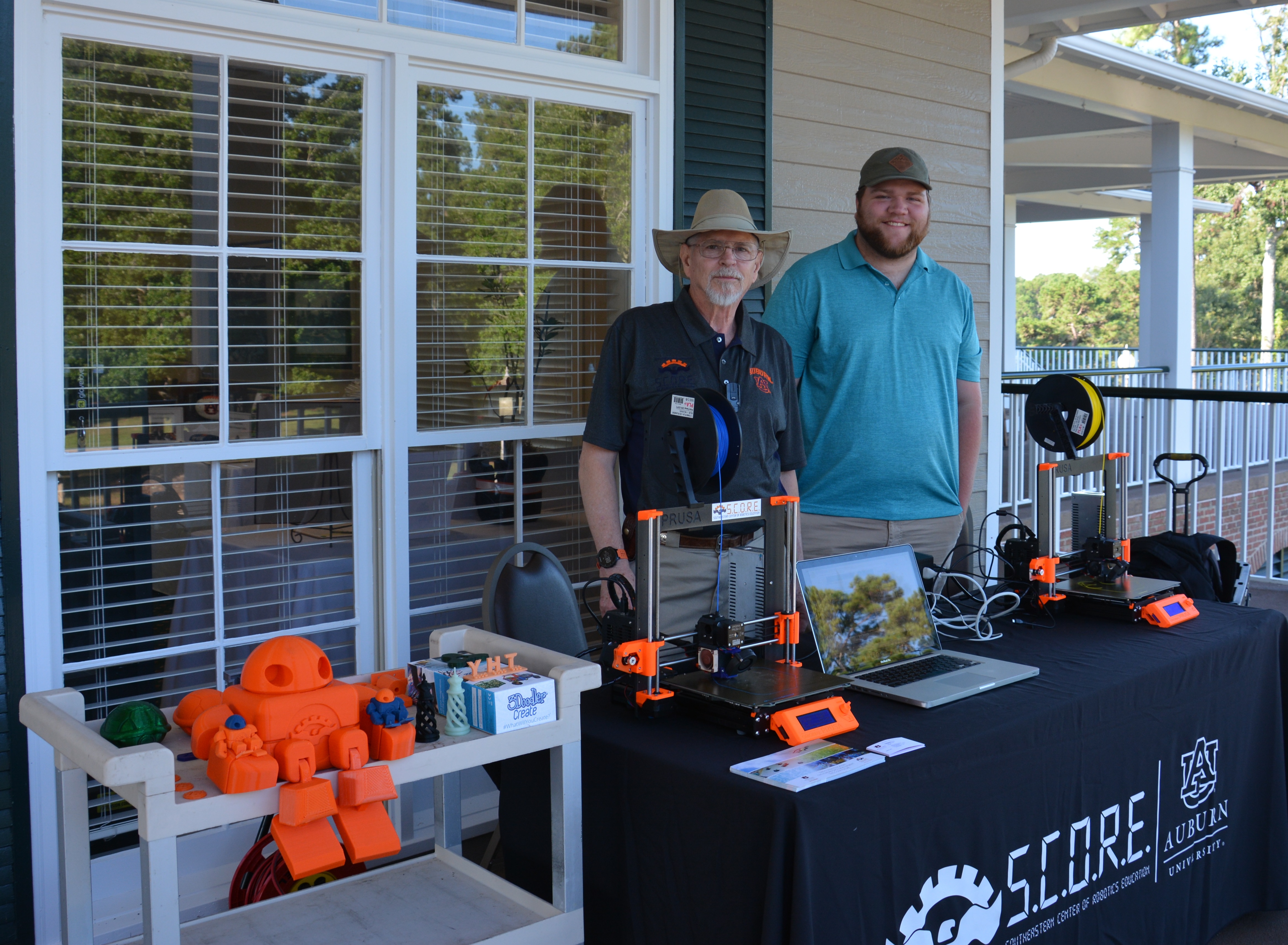 Frank Ware and Hunter Terry from Auburn’s Southeastern Center of Robotics Education (SCORE) demonstrate 3D printing. 