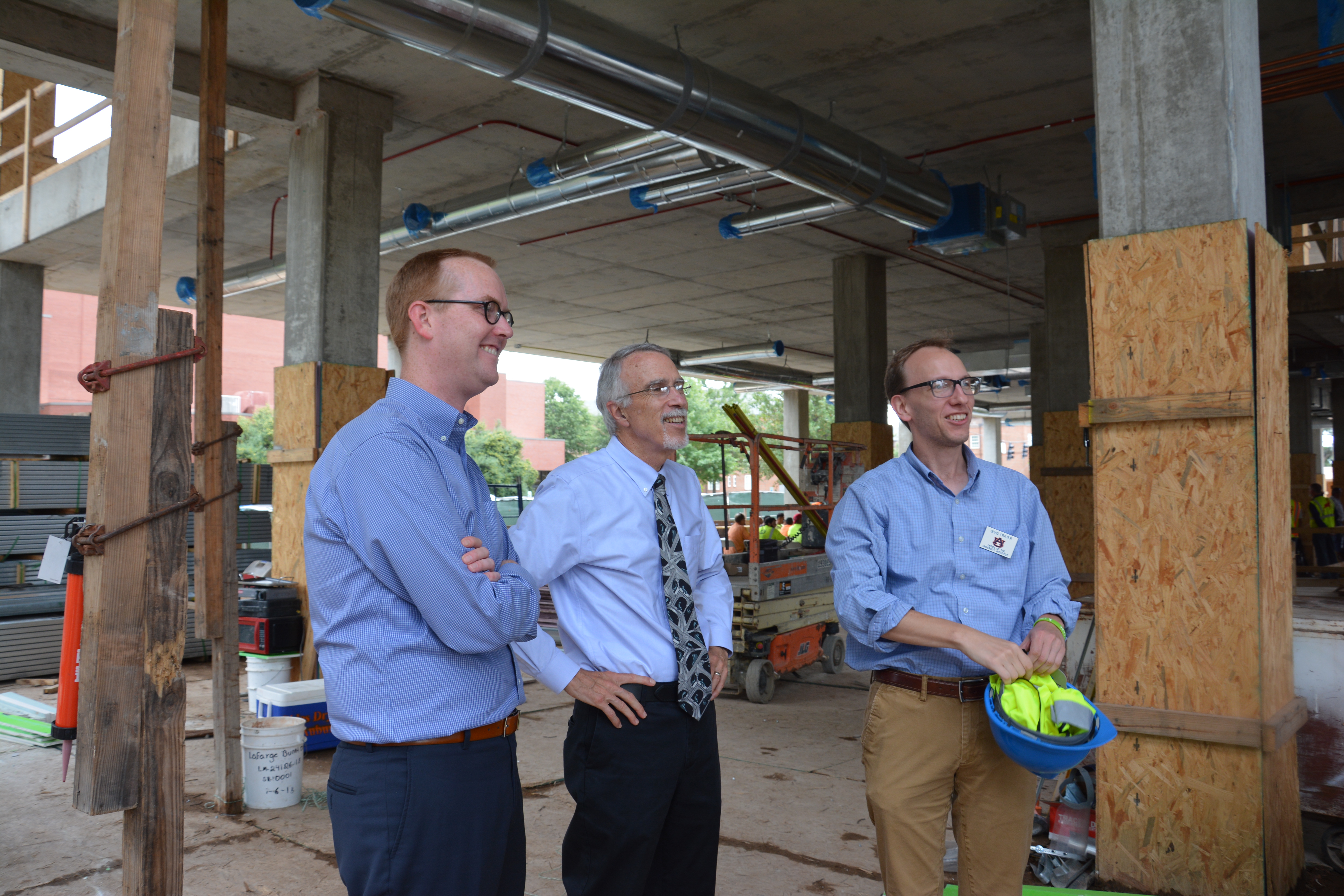 Simon Snyder, Dean Giordano and Brad Prater look at the concrete structure of the new Leach Science Center.