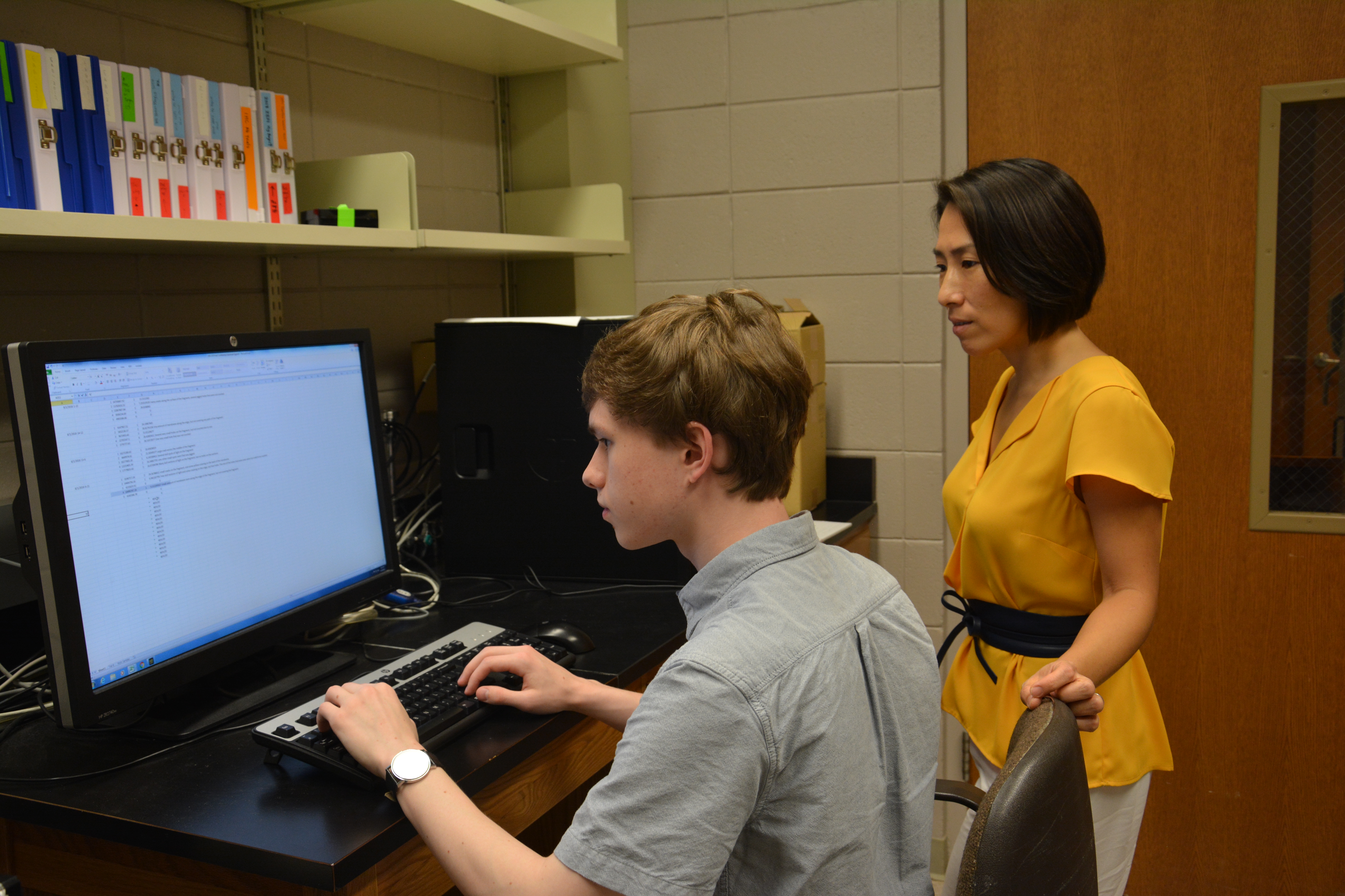 Leslie Dees and Dr. Haruka Wada reviewing data together. 