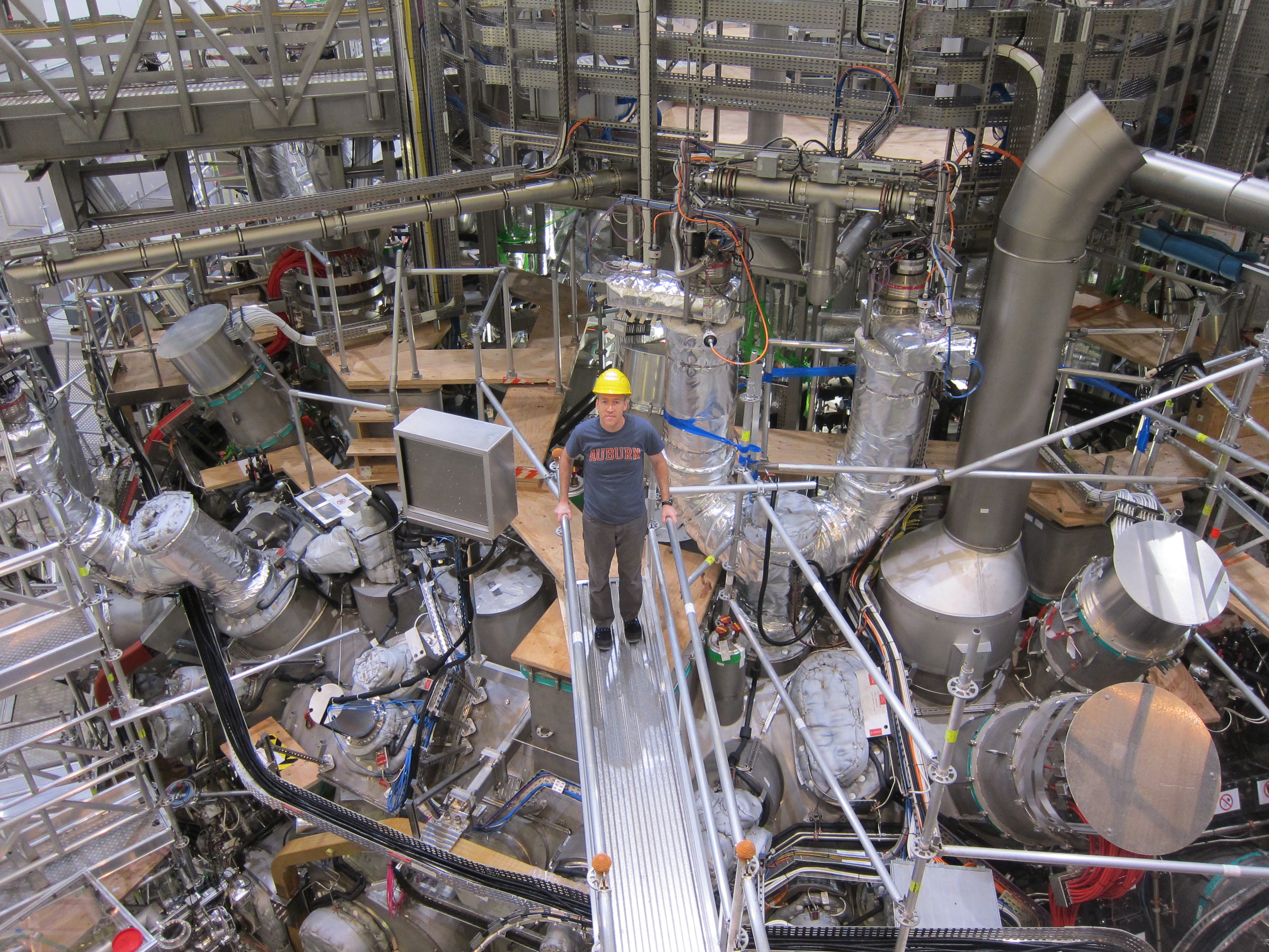 Dr. David Ennis standing on top of the Wendelstein 7-X experiment.