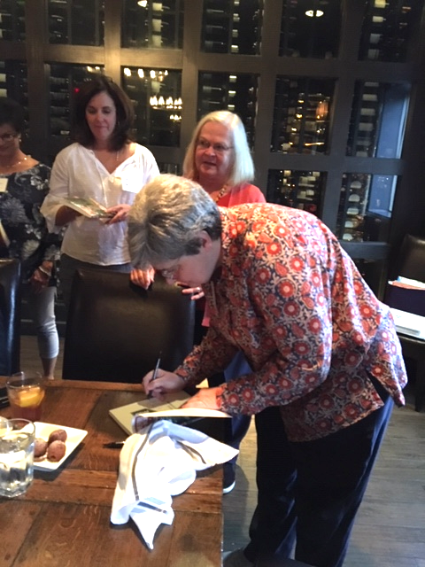 Mary Helen Brown signs books for guests.