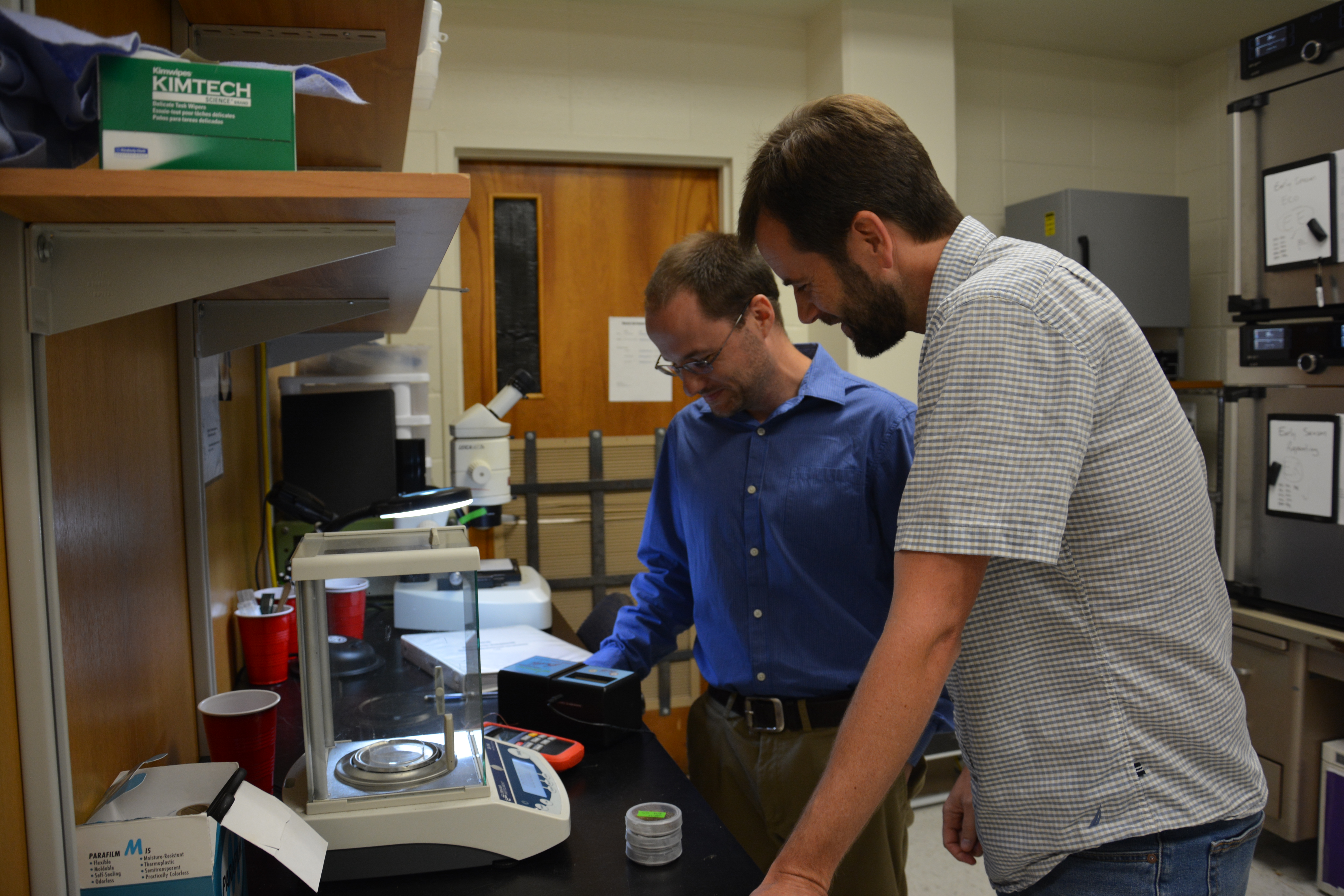 Dr. Warner with Josh Hall, a Ph.D. student, conducting research in his lab.