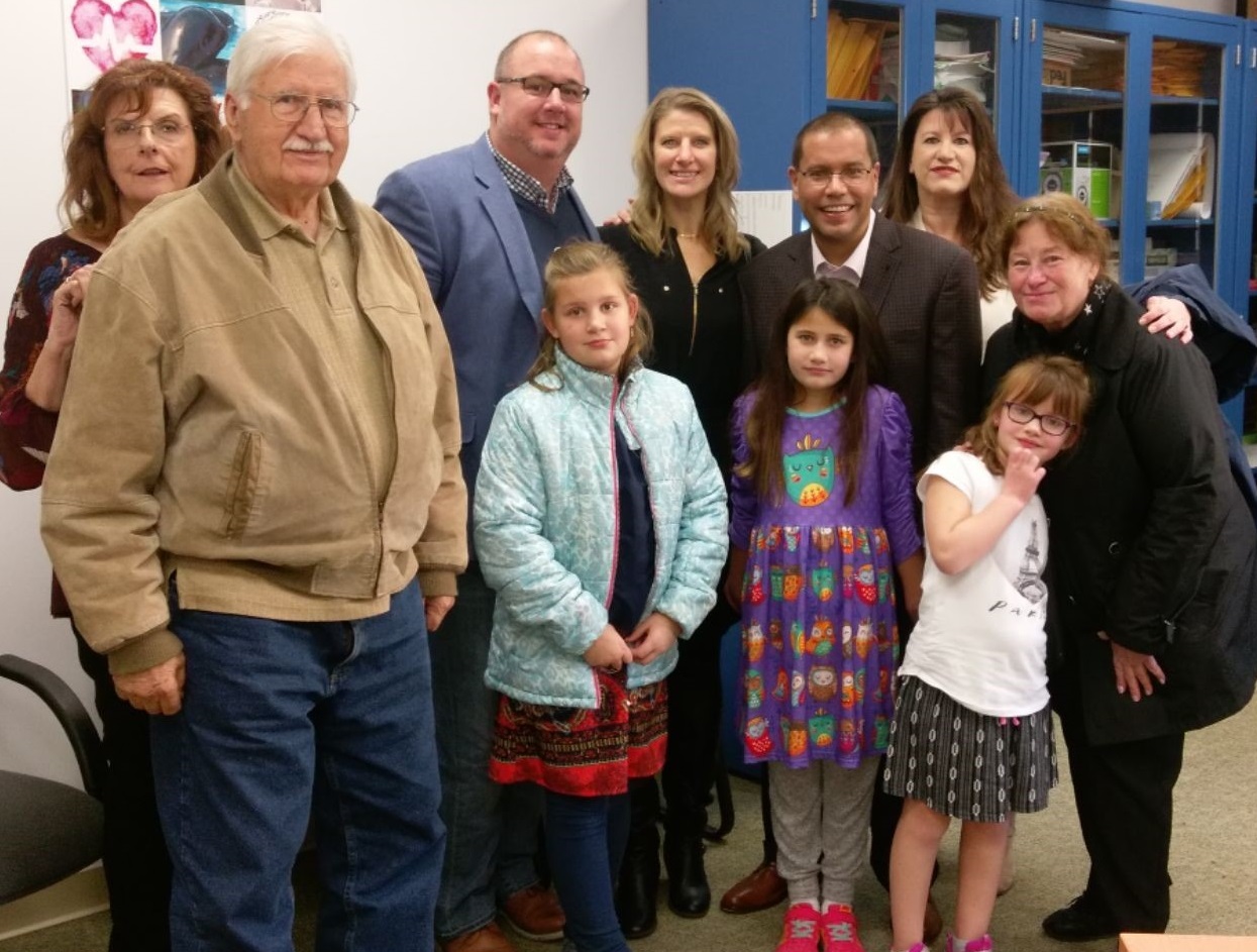 Dr. Scott Santos surrounded by his family at the University of Buffalo.