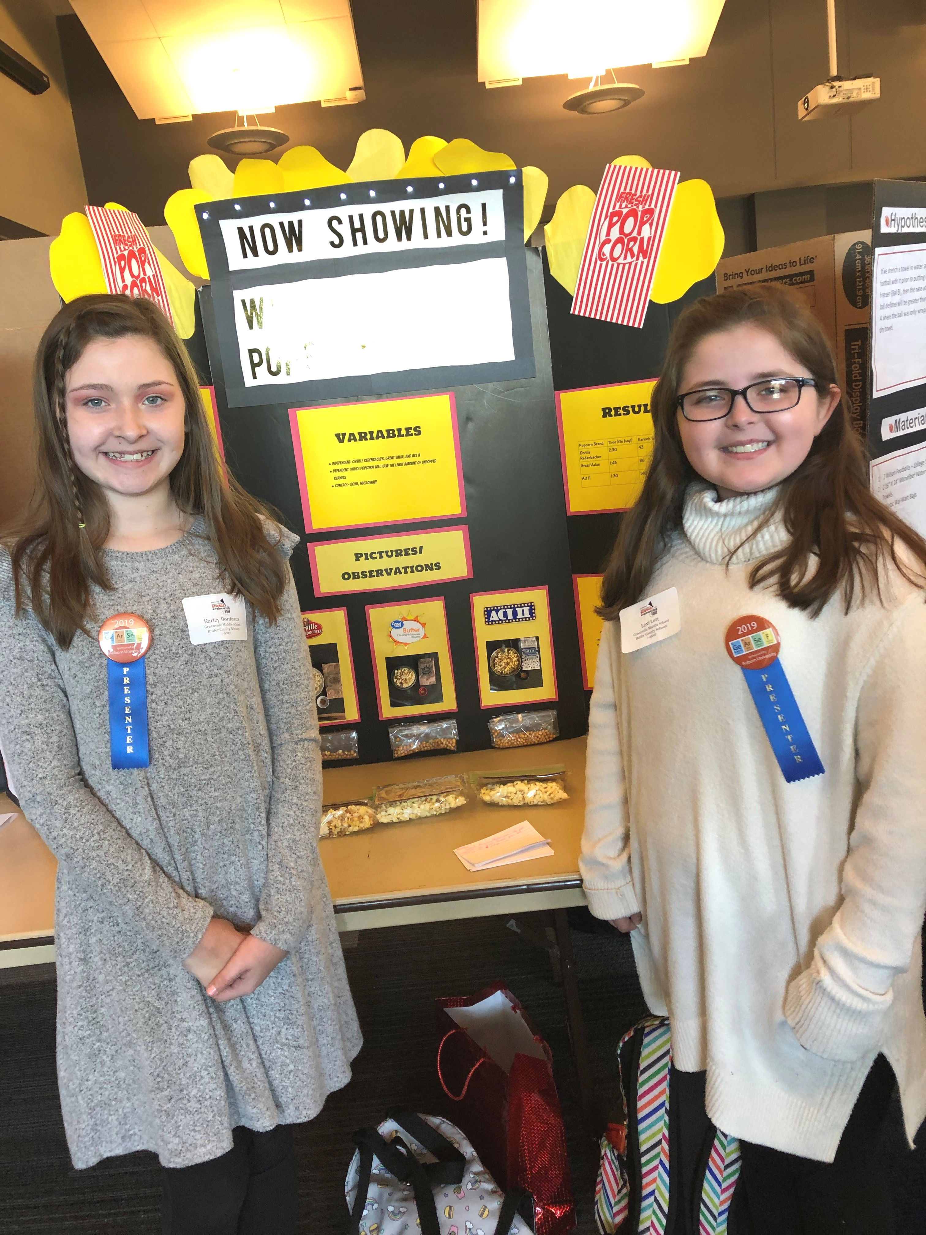 Karley Bordeaux and Lexi Lett from Greenville Middle School in Greenville, Alabama, proudly standing with their project “Which Popcorn Popped the Best?” at this year's event. 