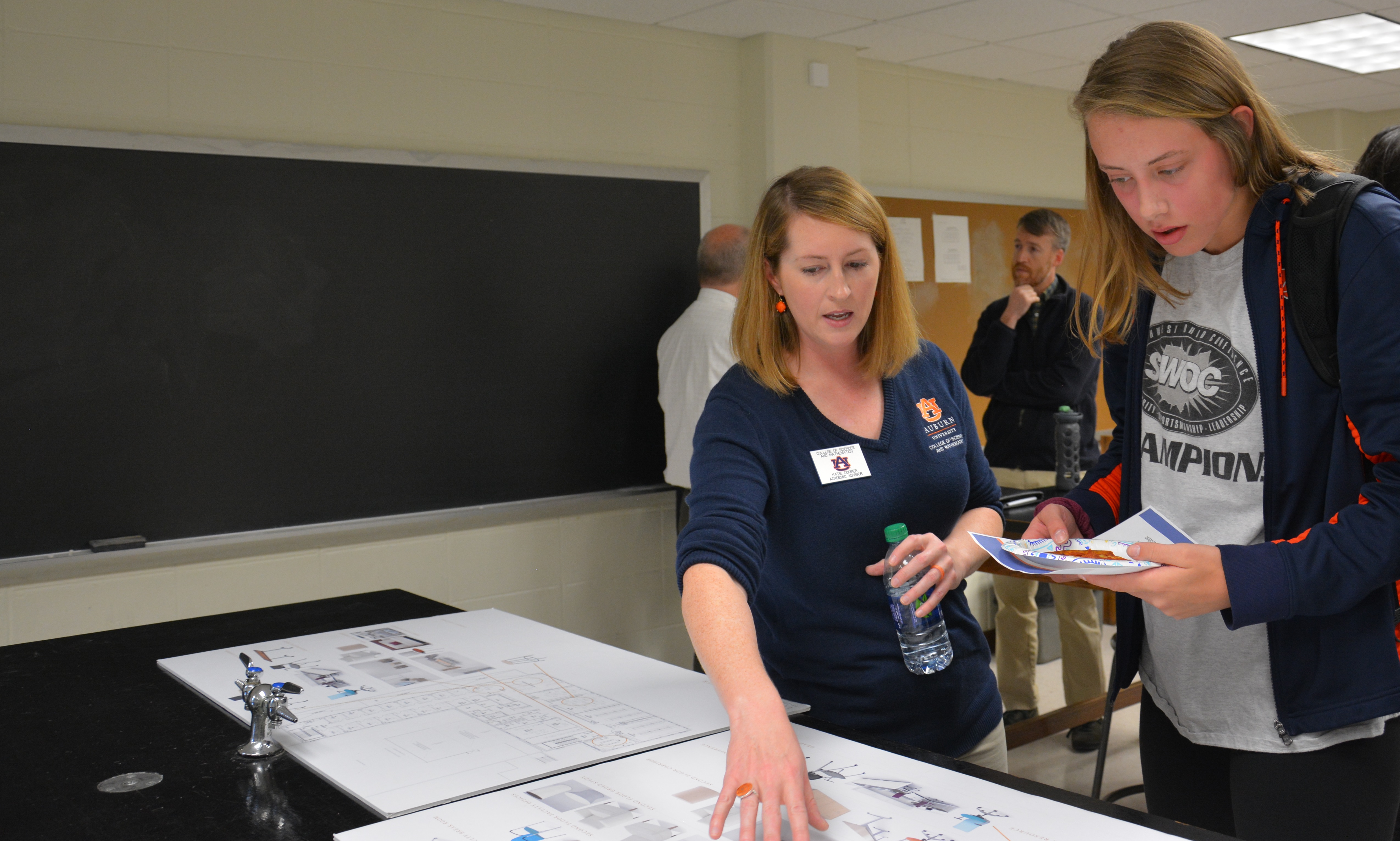 Katie Cooper (left) shares information about the new Leach Science Center Addition with future astrophysicist Valerie Green (right). 