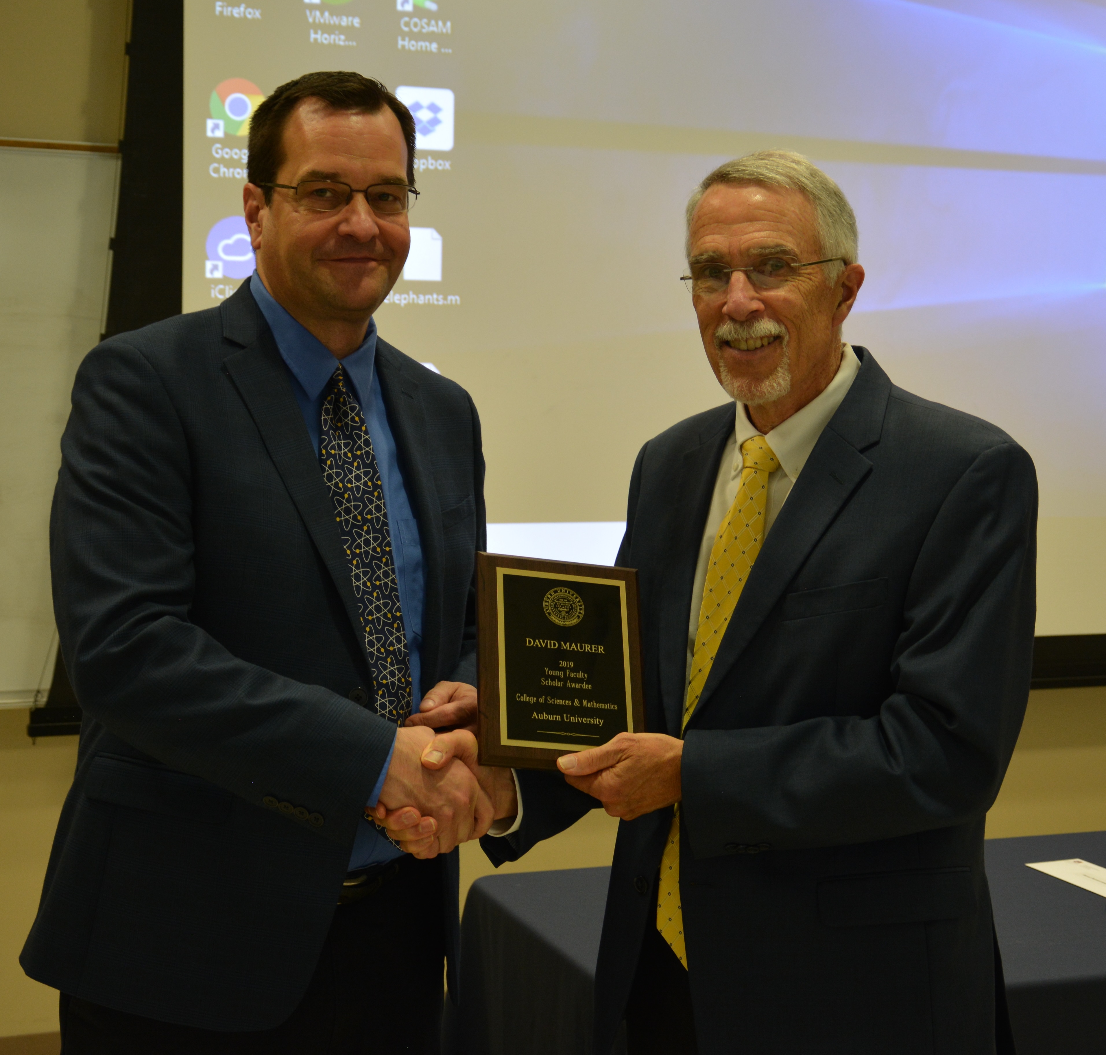 Dr. David Maurer, professor in the Department of Physics, receives the award as the Young Faculty Scholar Awardee from Dean Giordano.