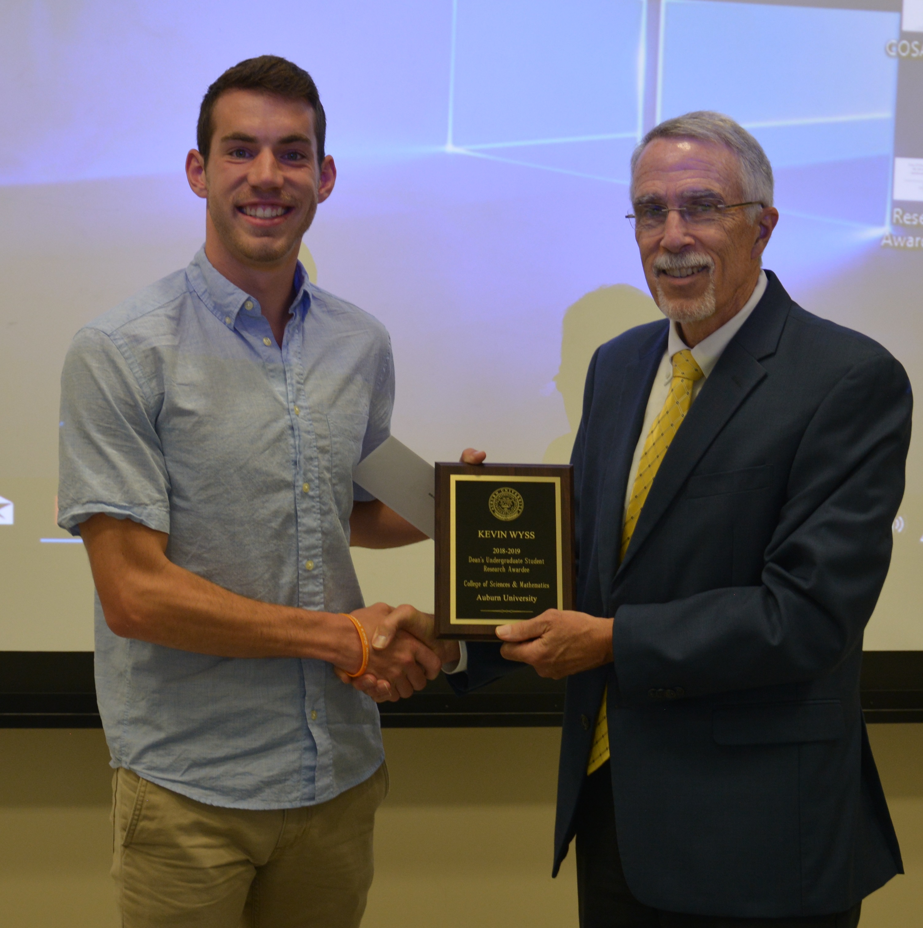 Kevin Wyss receiving the Undergraduate Student Award from Dean Giordano.