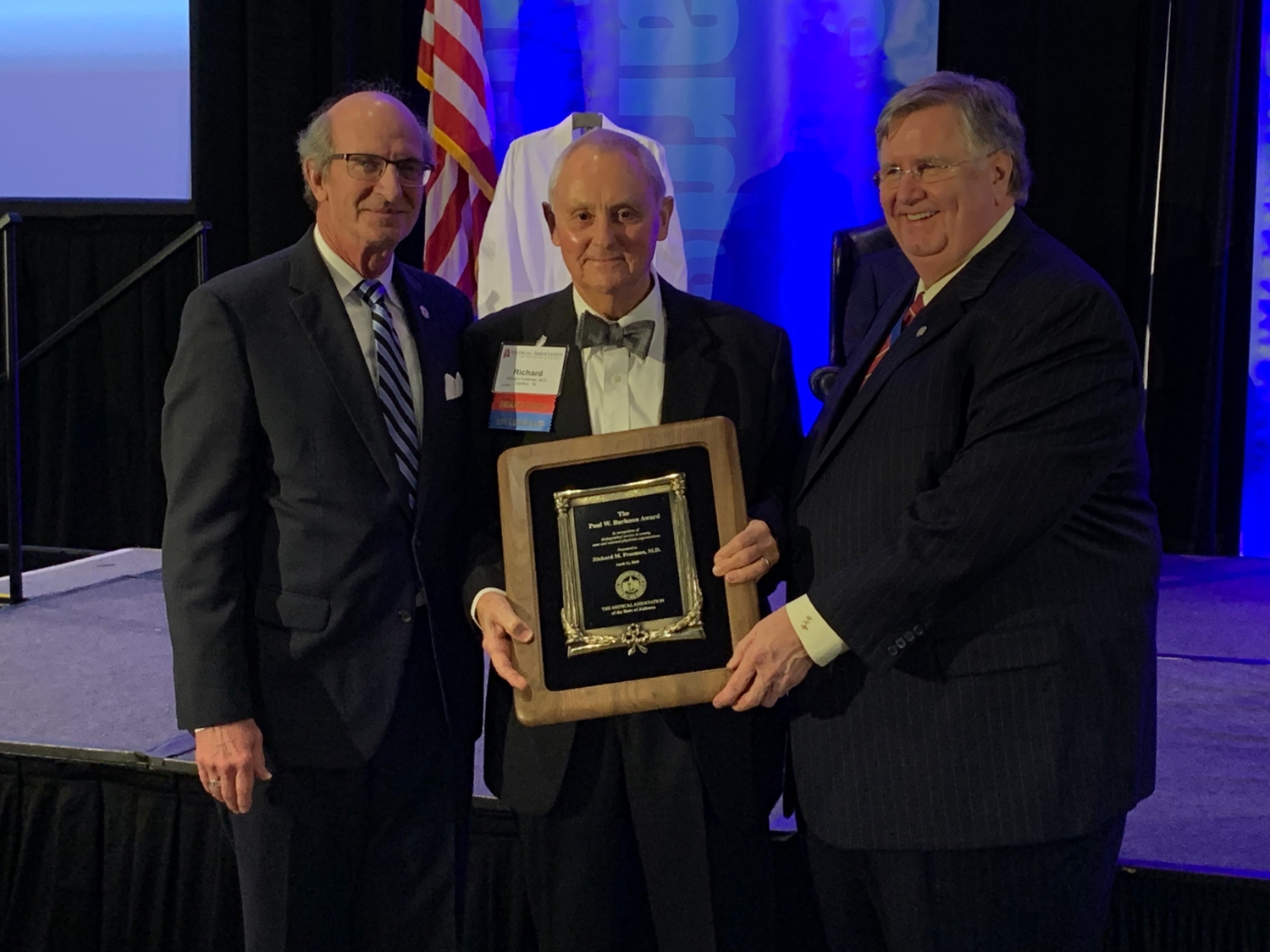 Richard M. Freeman, M.D., pictured in the middle, receives the prestigious 2019 Paul W. Burleson Award from the Medical Association of the State of Alabama. 