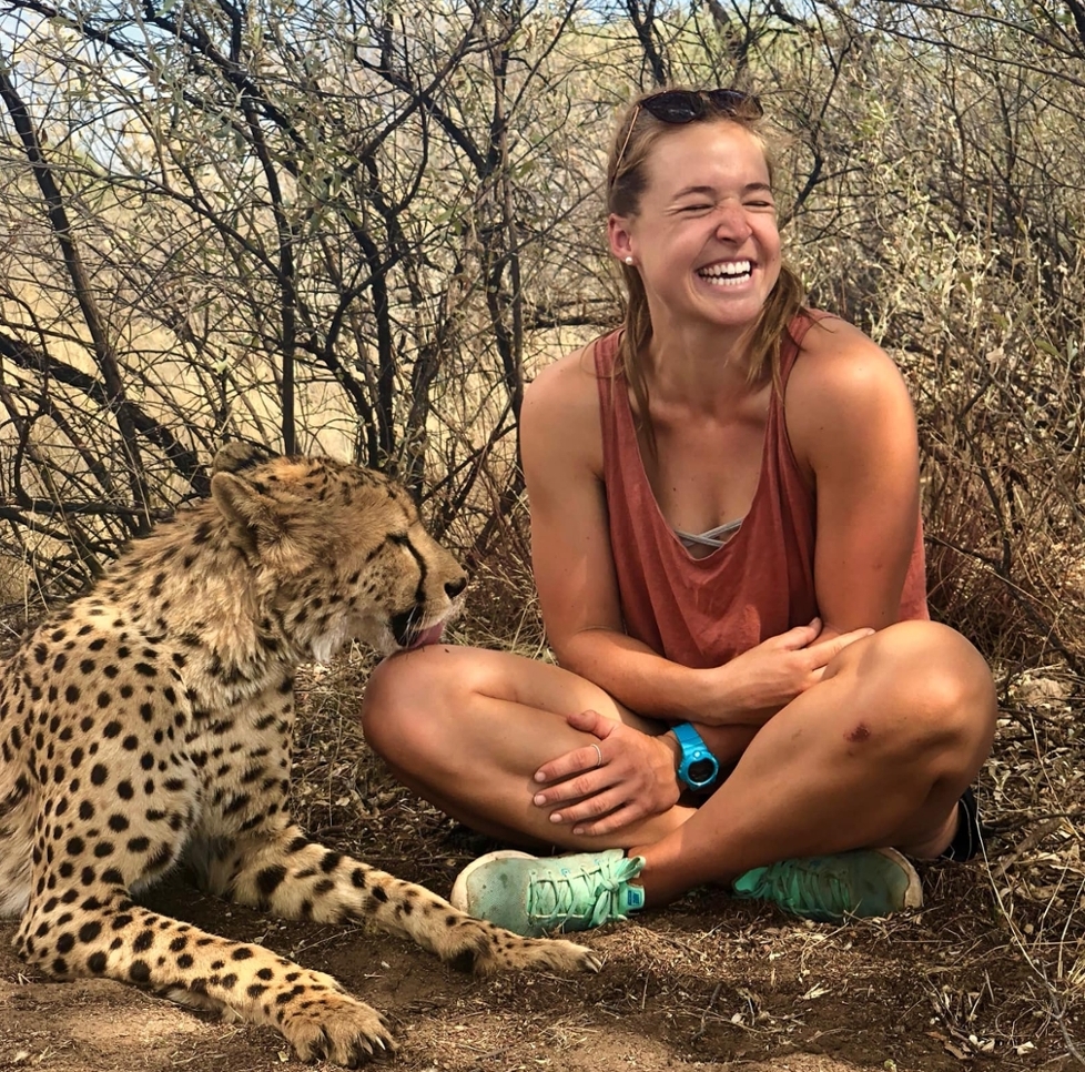 Natasha at the Harnas Wildlife Foundation, Namibia with a cheetah licking her leg.