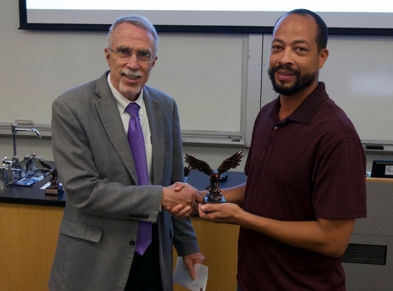 Dean Giordano presents a 2019 Lilly-Lovelace Distinguished Service Award to Darrick.