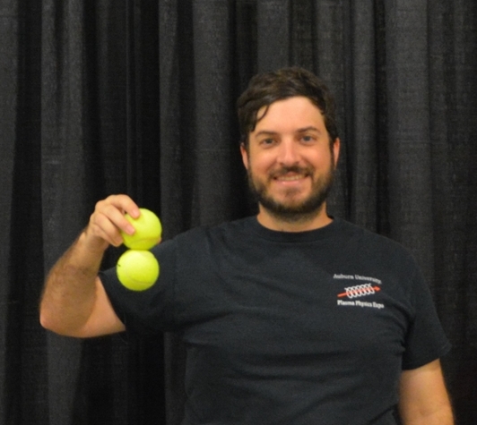 Spencer Le Blanc holds his favorite demonstration of tennis balls with magnets hidden inside at the 61st Annual Meeting of the APS Division of Plasma Physics. 