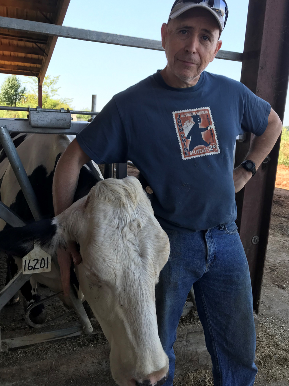 Transplant surgeon Dr. Marty Sellers shows his fun side posing with a cow.